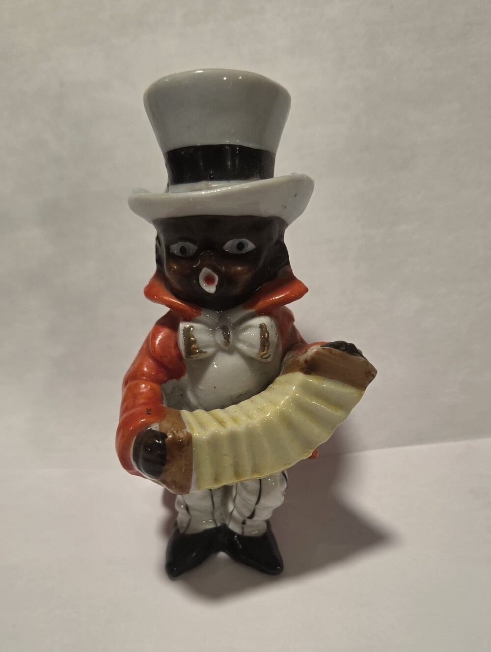 Bkack Americana Accoridian Figurine - White Hat, Red Coat